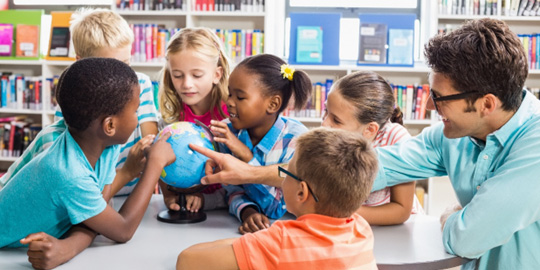 Classroom with students touching a globe